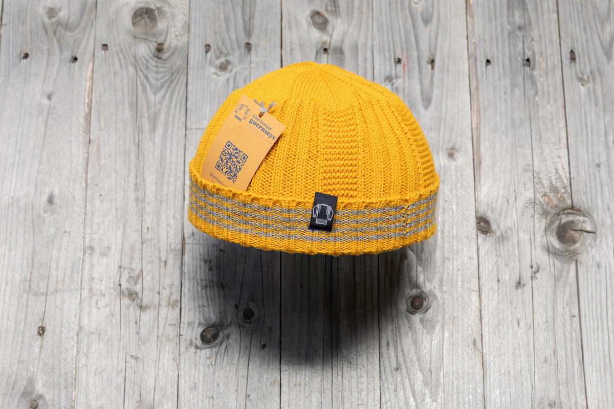 Yellow wool Hanois beanie with a ribbed knit, turn-back cuff, and three integrated reflective silver stripes.